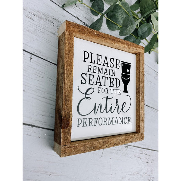 please remain seated for the entire performance sign