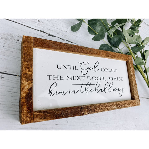 until god opens the next door praise him in the hallway sign