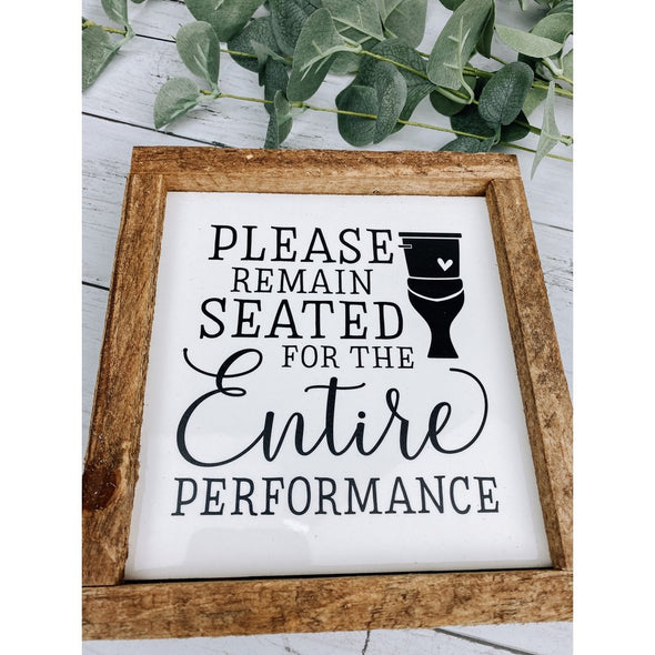 please remain seated for the entire performance sign 
